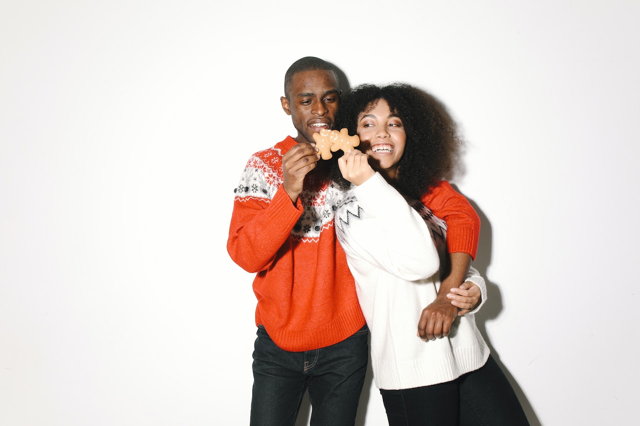 Woman and man wearing christams oversized sweaters